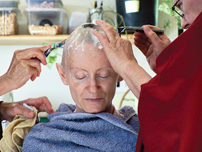 Venerable Samten having her head shaved.