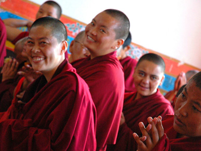 Happy Tibetan Buddhist nuns smiling.