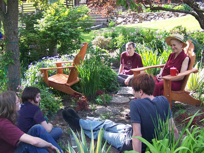 Venerable Chodron outside in a discussion with a group of youth.