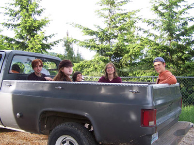 A group of young adult retreatants in back of the abbey truck.