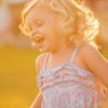 A young girl laughing in happiness.