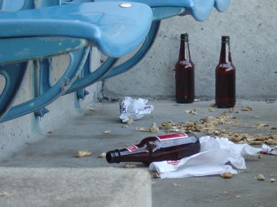 Empty beer bottles and trash on the ground.