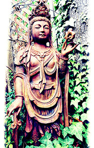 Statue of a bodhisattva in a garden.