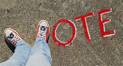 Shoes making the letter V in VOTE.