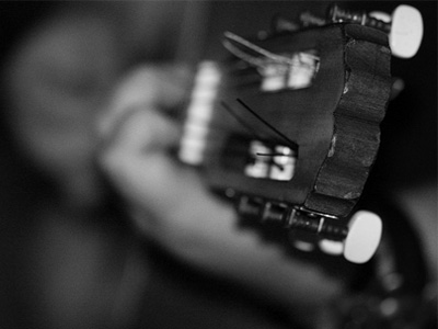 Closeup of hands of someone playing guitar.