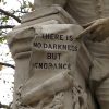 A statue hand pointing at the words: There is no darkness but ignorance.