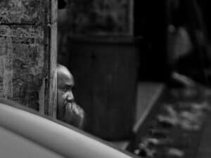 Black and white image of a man thinking.