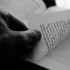 Hand turning the page of a book.