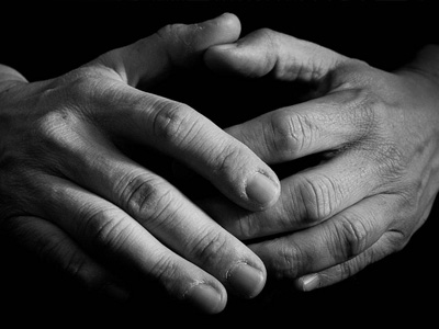 Hands held as if in contemplation.