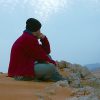 Man sitting alone, meditating.