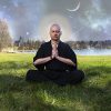 A man meditating outside.
