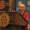 Venerable speaking behind the podium at the Rotary Club in Spokane.