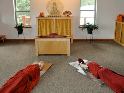 Venerable Samten and Venerable Jampa prostrating in front of the Abbey altar.