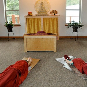 Venerables Samten and Jampa prostrating in front of the Abbey altar.