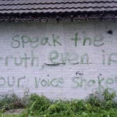 "Speak the truth even if your voice shakes" painted on a wall.