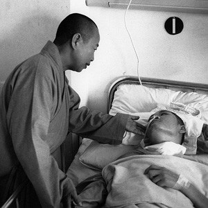 Buddhist nun comforting a patient at Tzu Chi Hospital.