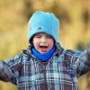 An angry young boy, appearing to be shouting.