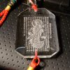 Heart sutra written in chinese wordings and the image of guan yin on a crystal pendant.