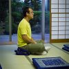 Lay teacher sitting in meditation posture.