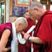 Venerable Chodron bowing to His Holiness the Dalai Lama.