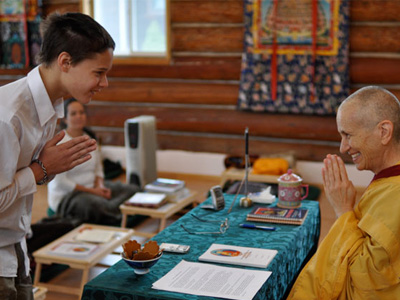 Young Abbey retreatant bowing to Venerable Chodron.
