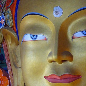 Close-up of golden Buddha's face.