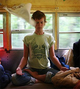 Woman meditating in a camper.