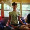 Woman meditating in a camper.
