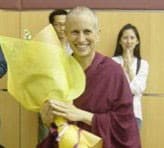 Venerable Chodron smiling and holding flowers at Tai Pei Buddhist Centre in Singapore.