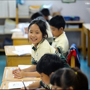 Young girl smiling in classroom.