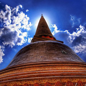 Stupa with sunlight in background.