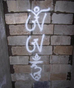 Om Ah Hum spray painted on bricks.
