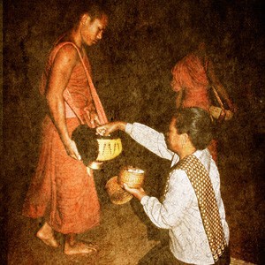 Lay person giving alms to monk.