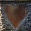 Heart carved in stone wall.