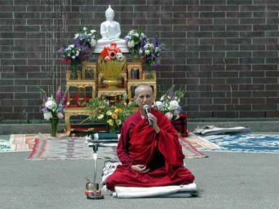Venerable Chodron in front of altar, teaching.