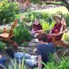 Venerable Chodron having a discussion outside with a group of youth.