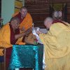 Venerable Chodron offering a mandala to Khensur Rinpoche.