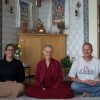 Venerable sitting in front of altar with Rachel and Jesse from Missoula.