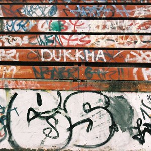 Alot of wordings scribbed on the wall, middle is the word - Duhhka.