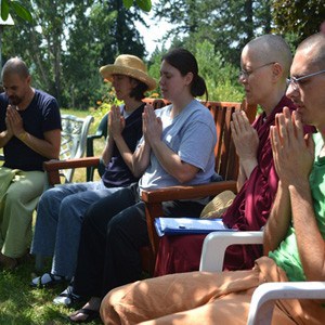 Exploring Monastic Life (EML) retreatants sitting in chairs praying.