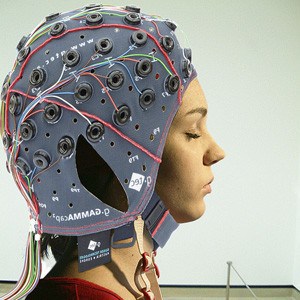 Woman with computer instrument connected to her head.