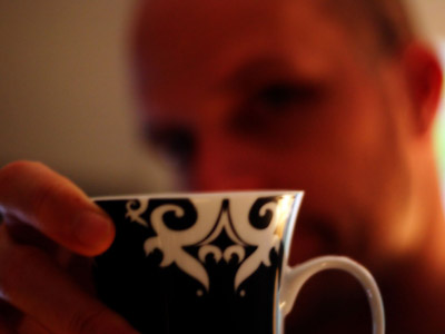 A man taking a coffee cup.