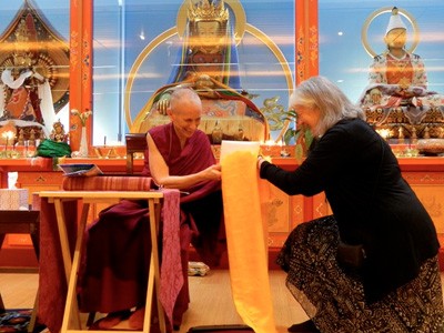 Venerable receiving an offering after a teaching at Maitripa.