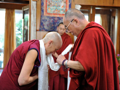 HH Dalai Lama placing a khata over Venerable Thubten Chodron.