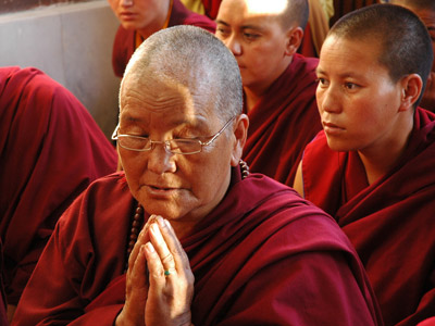 A tibetan nun praying.