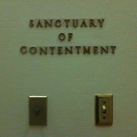 A wall with the words: Sanctuary of Contentment
