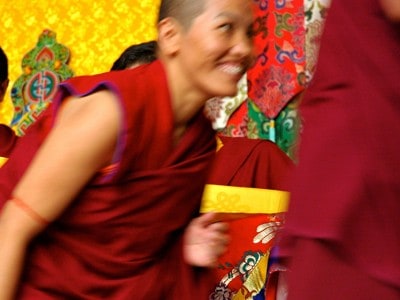 A Tibetan nun smiling.