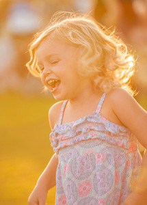 A young girl laughing in happiness.