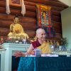 Venerable Chodron teaching the Dharma and smiling very happily.