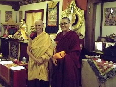 Venerable Chodron and Venerable Tenzin Kacho, standing in front of an altar at Vajrapani Institute in Boulder Creek.